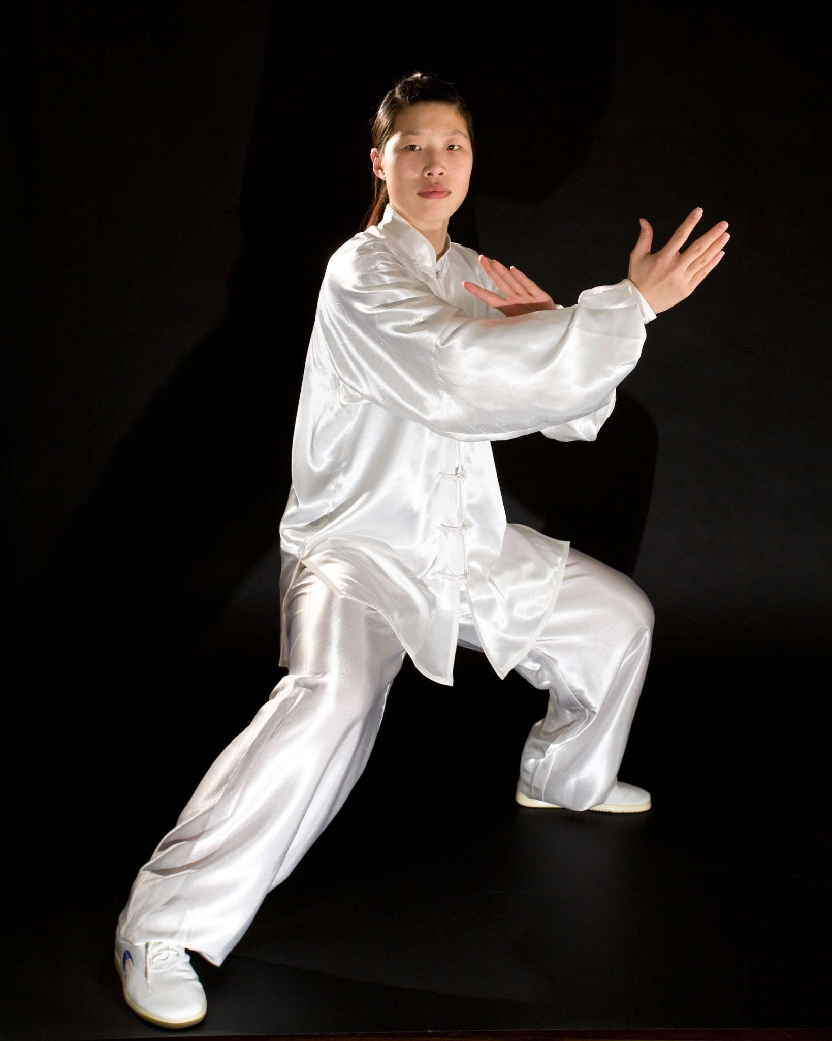 Master Chen Huixian demonstrating a traditional Chen Taijiquan posture in formal white silk